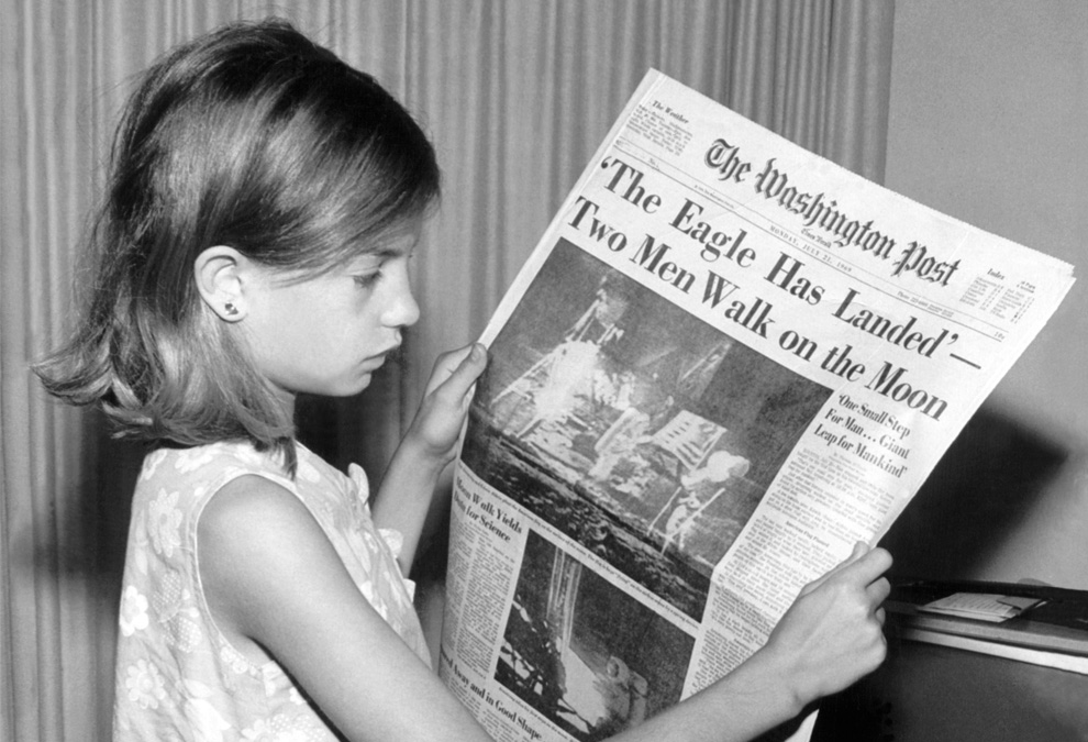 A-girl-reads-Apollo-11-moon-landing-report-in-The-Washington-Post-July-21-1969.jpg