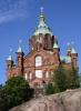 Eindrucksvoller roter Backsteinbau mit 13 vergoldeten Kuppeln, der erhöht auf felsigem Grund liegt: die Uspenski-Kathedrale.